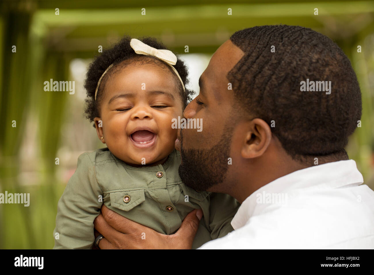 African American father holding his daughter. Stock Photo