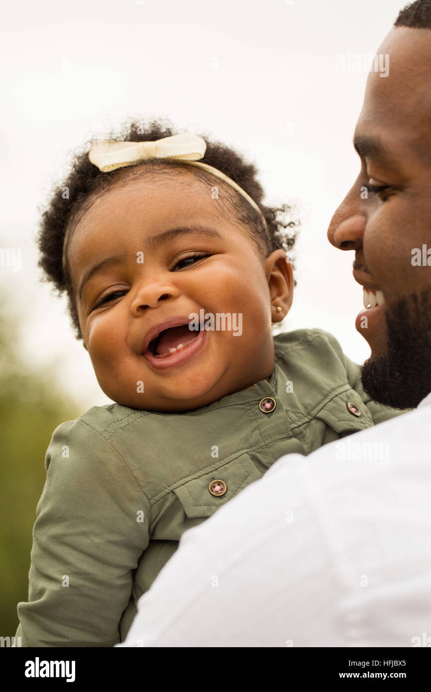 African American father holding his daughter Stock Photo - Alamy