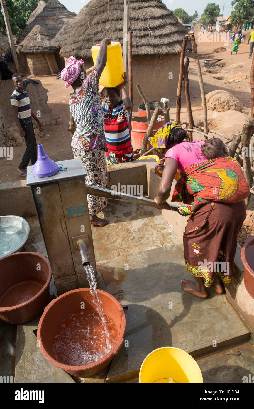 Kiniero, Guinea, 30th April 2015: This village and the surrounding area will be flooded by the Fomi Dam. Women pulling water from a well near the centre of the village. Stock Photo