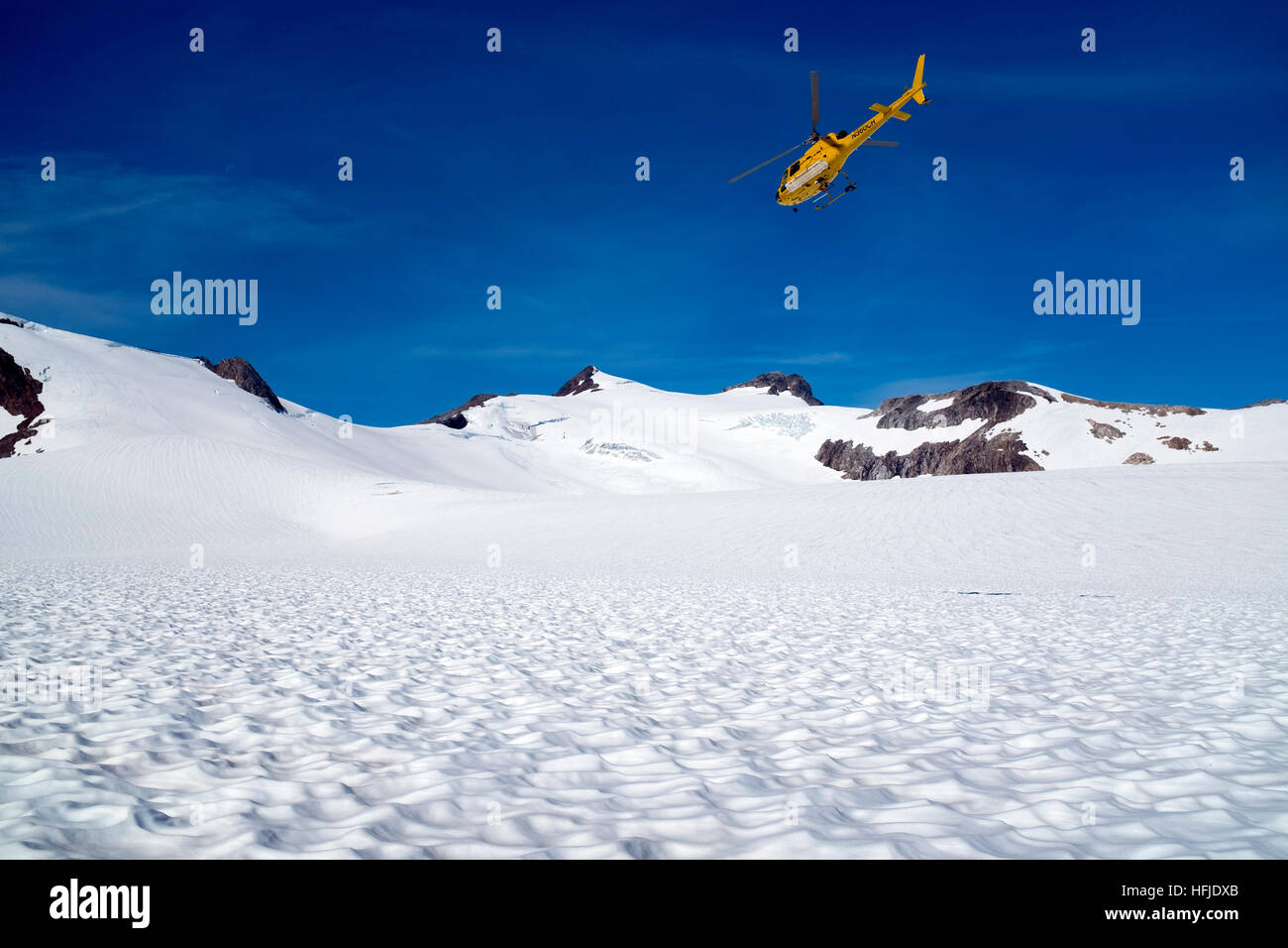 Helicopter flying low over the glacier in Alaska USA. Stock Photo