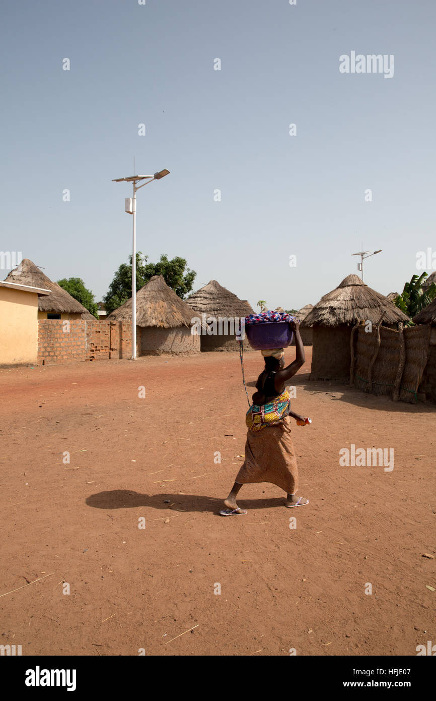 Baro village, Guinea, 1st May 2015: Solar powered street lighting, very recently installed. Stock Photo