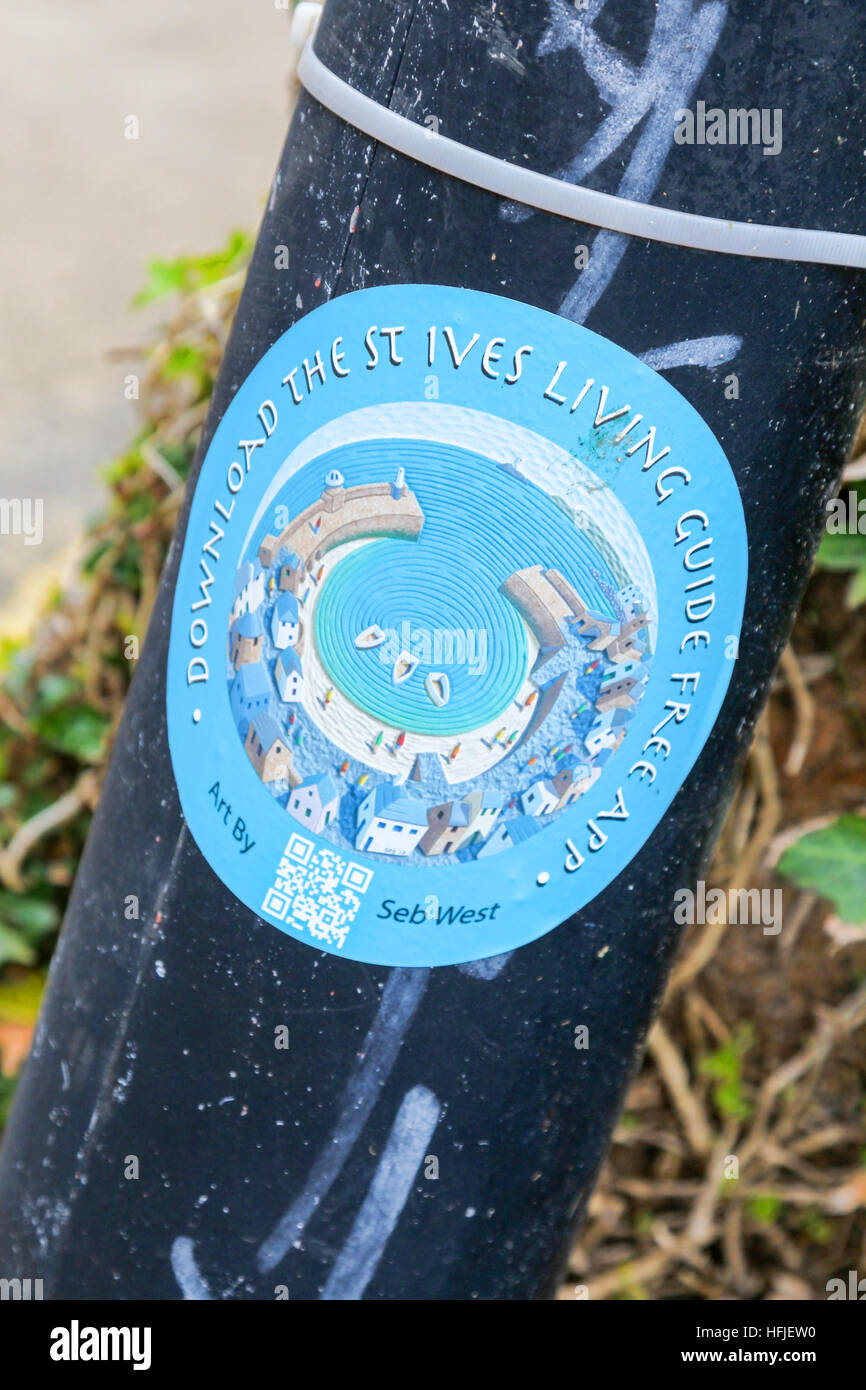 A sticker on a post saying download the St Ives living guide free app St Ives Cornwall South West England UK GB Stock Photo