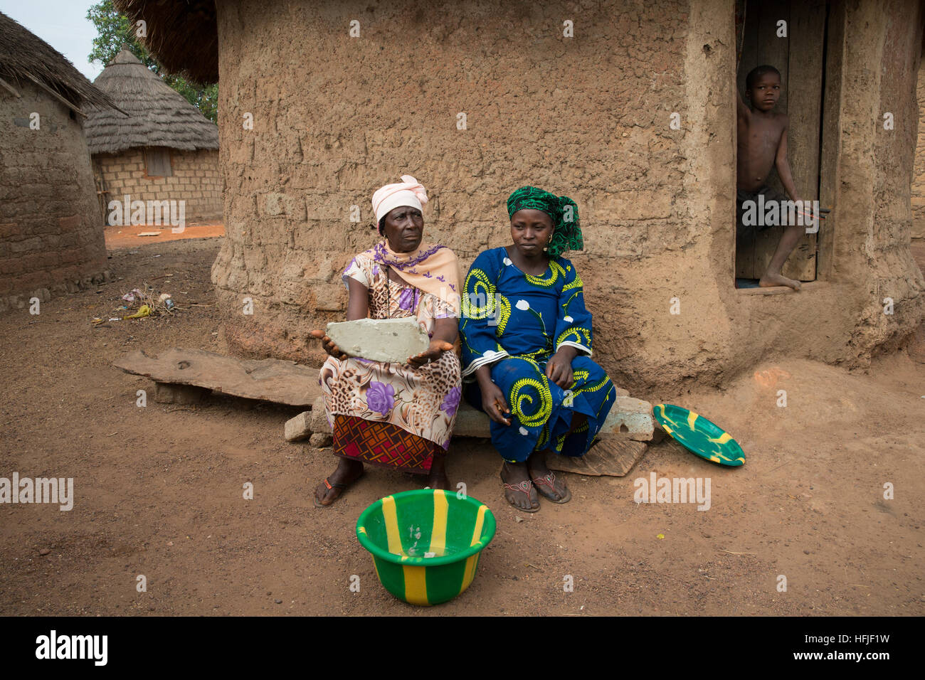 Koumban village, Guinea, 2nd May 2015; Sona Sacko, 75,  and her daughter Tenein Doumbouya, 35, are Shea butter sellers. Stock Photo