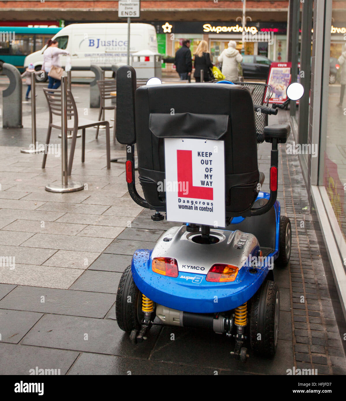 'L Plates' Dangerous woman driver Warning Sign on Mobility Scooter, handicapped transport, battery powered, wheelchair user, retirement vehicle in Chapel Street, Southport, Merseyside, UK Stock Photo