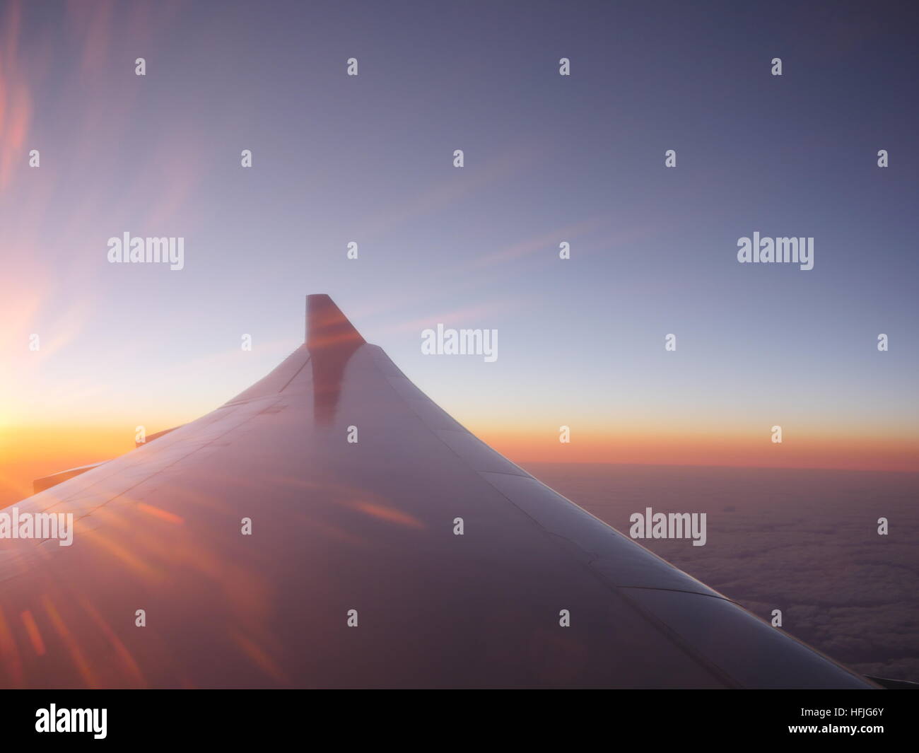 Airplane wing at sunset Stock Photo