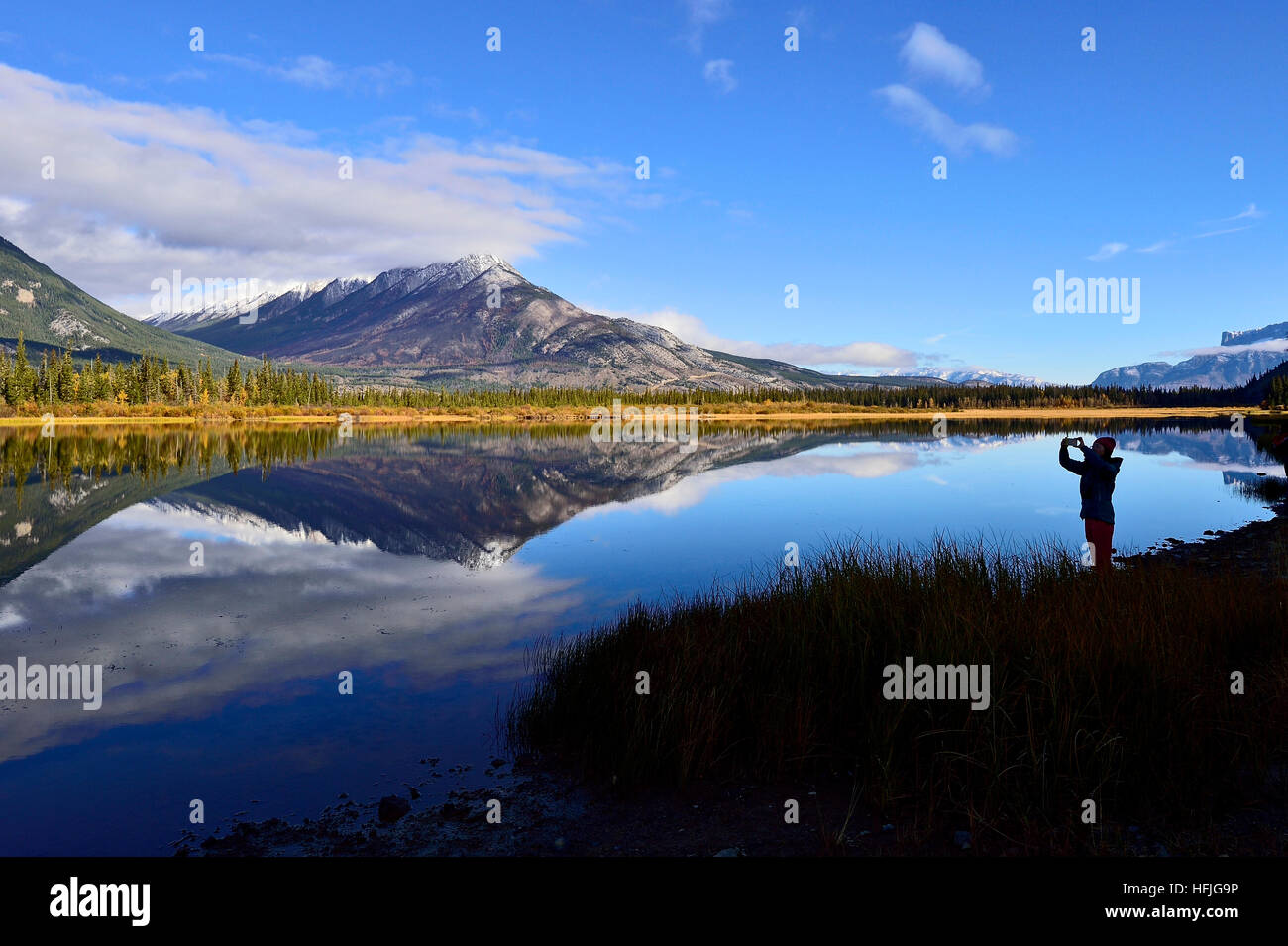 A landscape image of a mountain reflection in Jasper Lake in Jasper National Park Alberta Canada Stock Photo