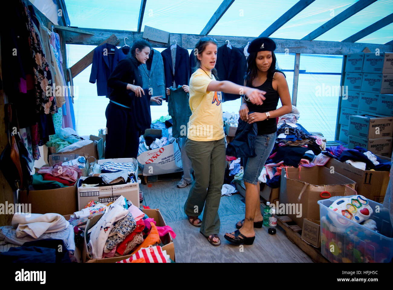 Young Hurricane Katrina relief workers gather food clothing and supplies for affected local residents at a damaged church. Stock Photo
