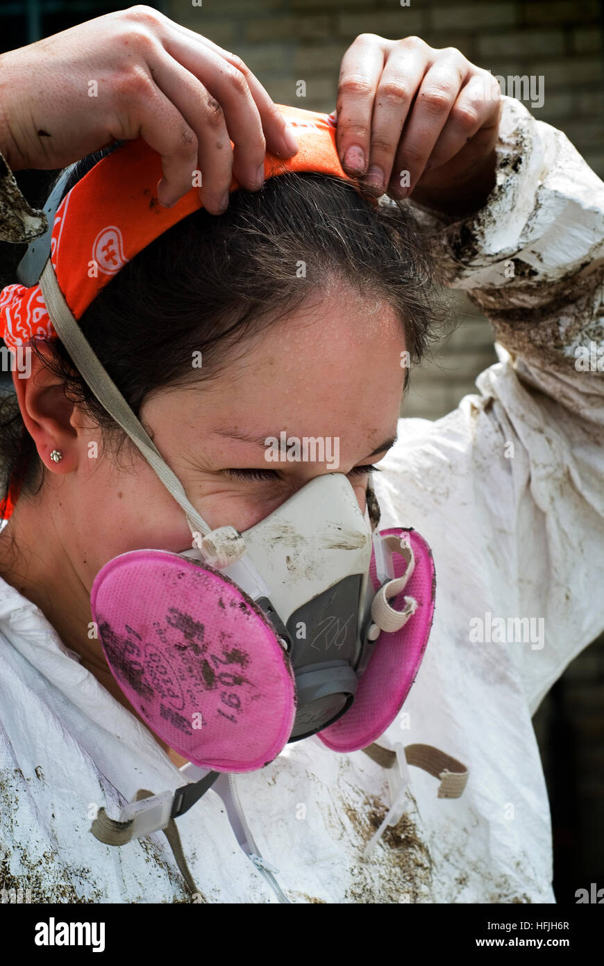 Volunteers in protective gear strip heavily molded drywall and contents from Hurricane Katrina affected homes in New Orleans, LA Stock Photo