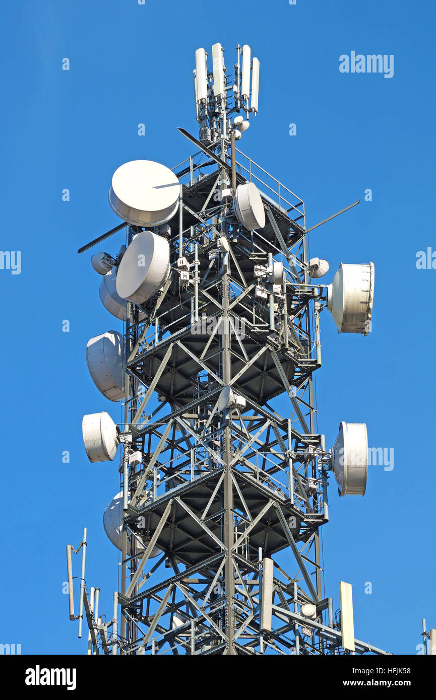 Telecommunication pole tower television antennas with blue sky Stock Photo