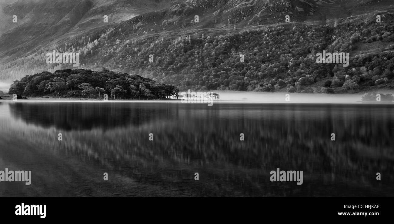 Stunning black and white Autumn Fall landscape image of Crummock Water at sunrise in Lake District England Stock Photo