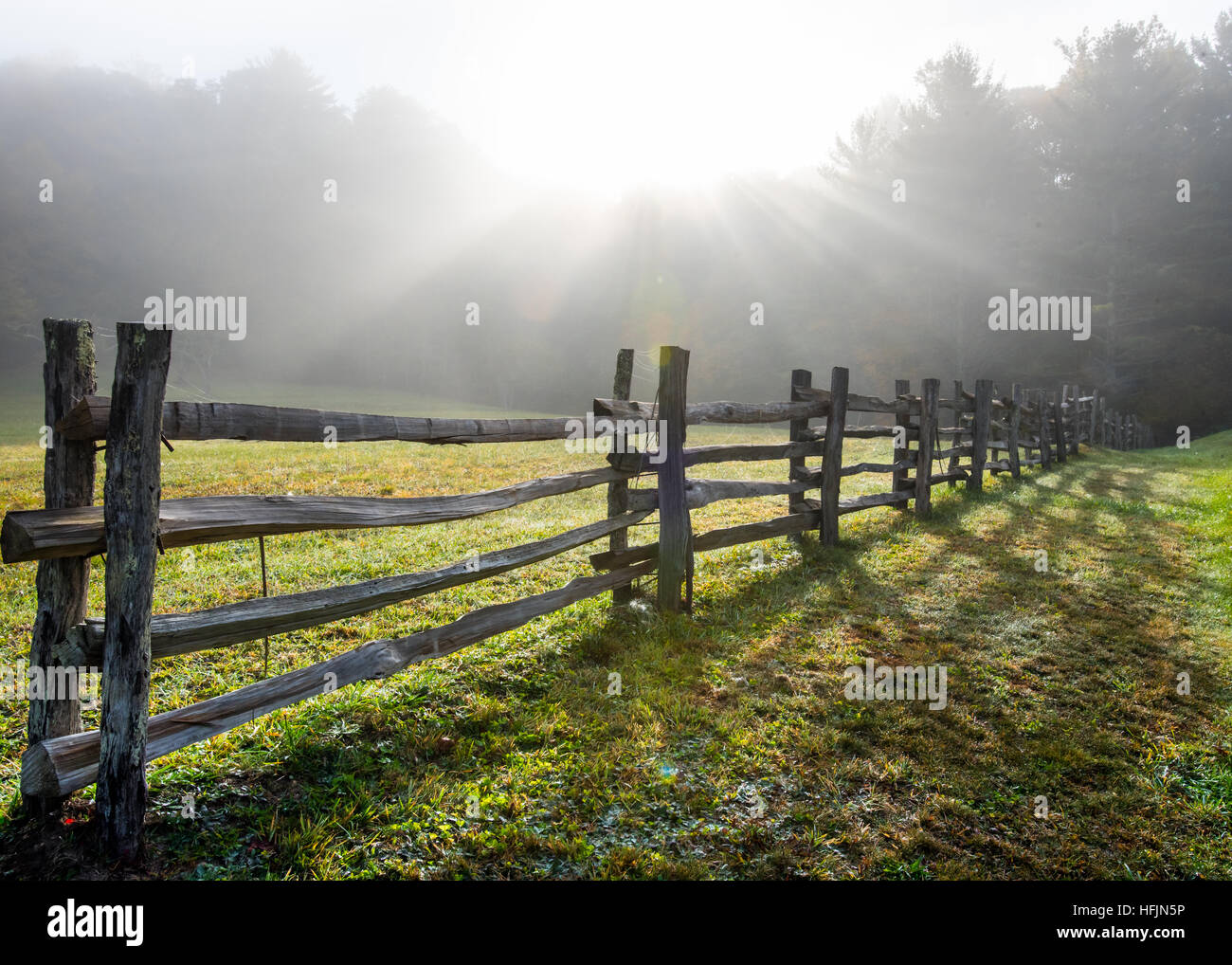 Sun Rays in Foggy Field and Split Rail Fence Horizontal Stock Photo - Alamy