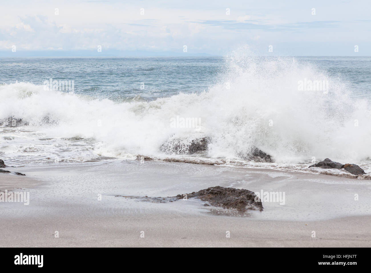 Waves crashing to rocks montezuma beach Costa Rica Stock Photo Alamy