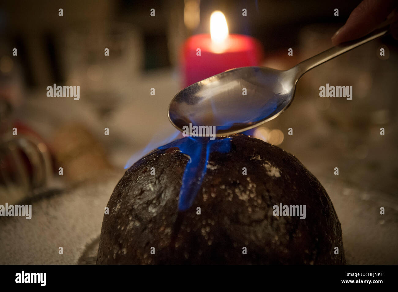 Christmas pudding with brandy alight on it Stock Photo