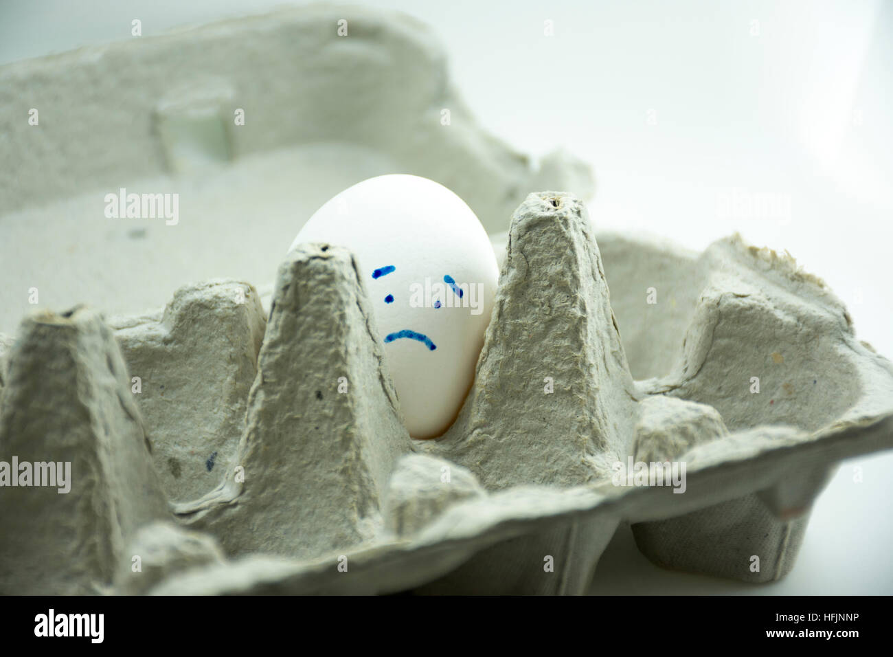 sad white lonely egg Stock Photo