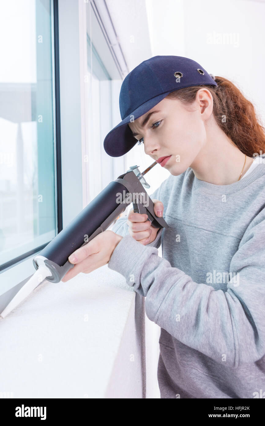 Woman using caulking gun Stock Photo Alamy