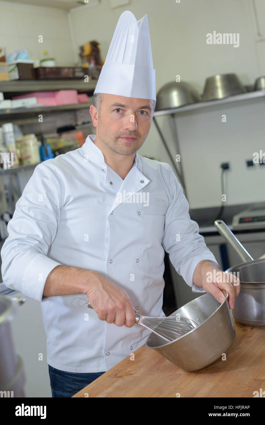 pastry chef holding delicious looking cakes and pastries Stock Photo