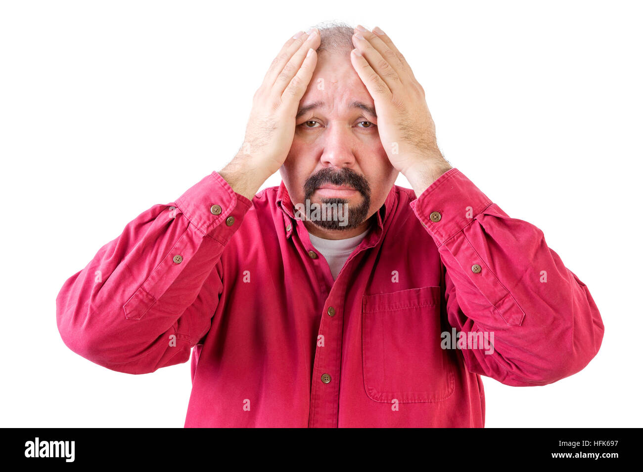 Depressed middle aged man with goatee beard and head in hands on white Stock Photo