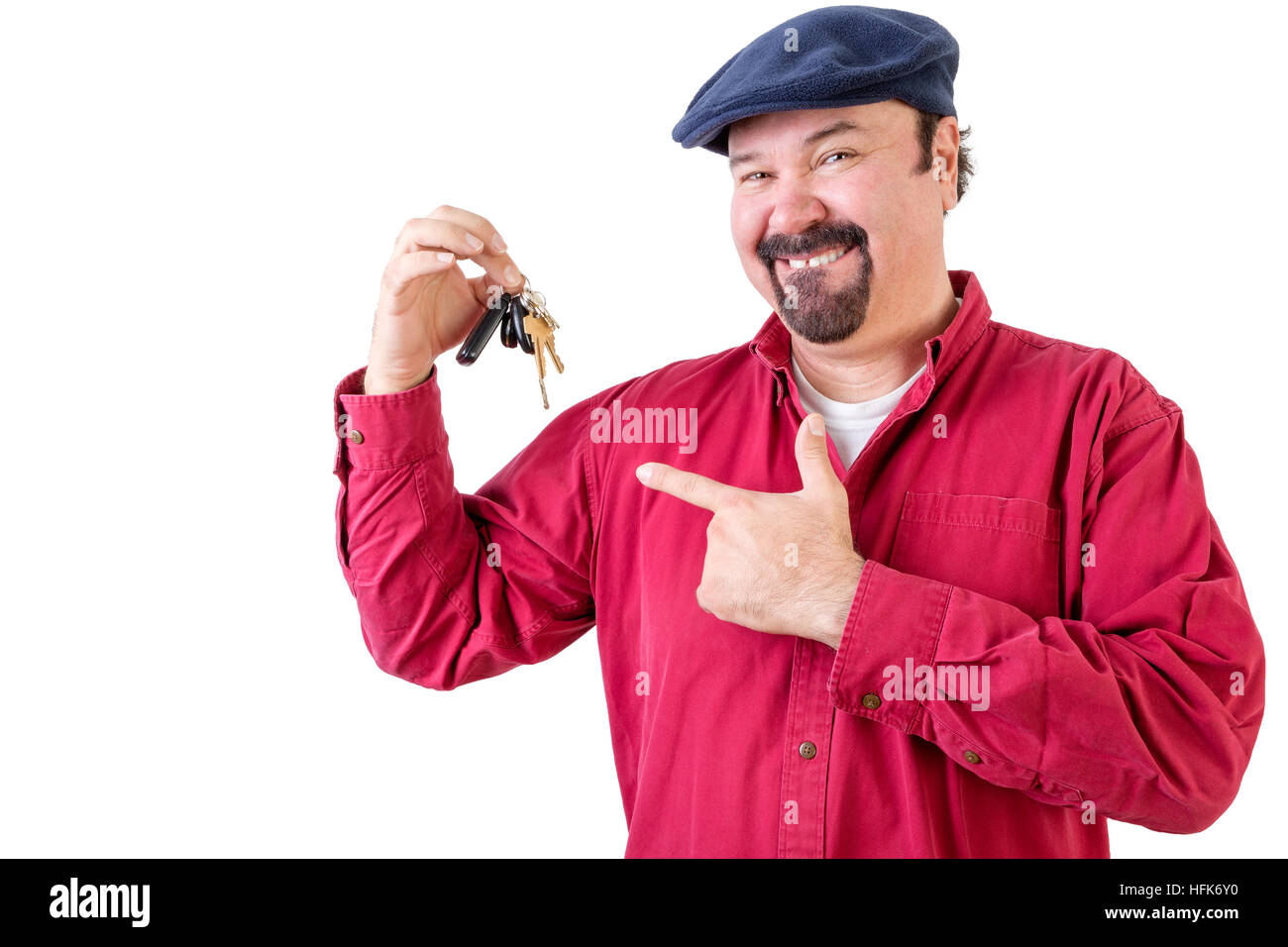 Proud middle-aged man feeling very privileged in his achievement pointing to his new car keys with a satisfied happy smile, upper body on white Stock Photo