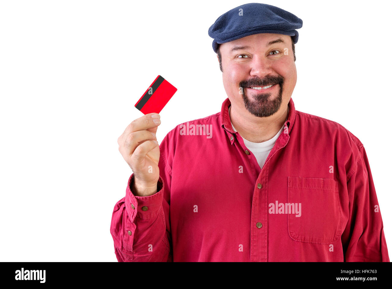Motivated man with a bright idea holding a credit card up in his hand with a big smile as he imagines the opportunities that it opens up for him if he Stock Photo