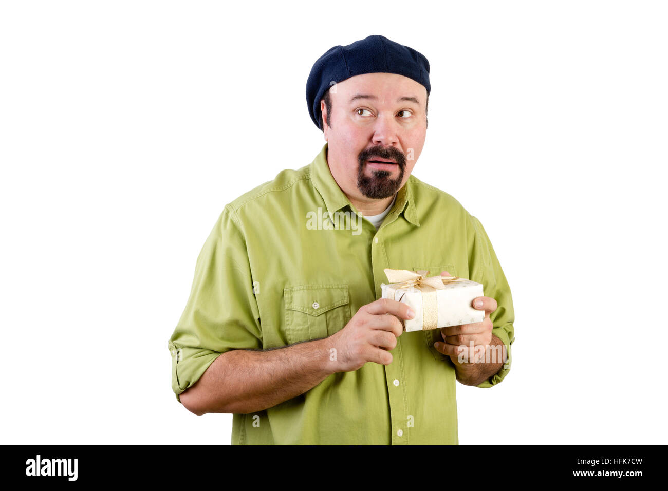 Half body portrait of nervous middle aged man with wrapped present glancing to side on white Stock Photo