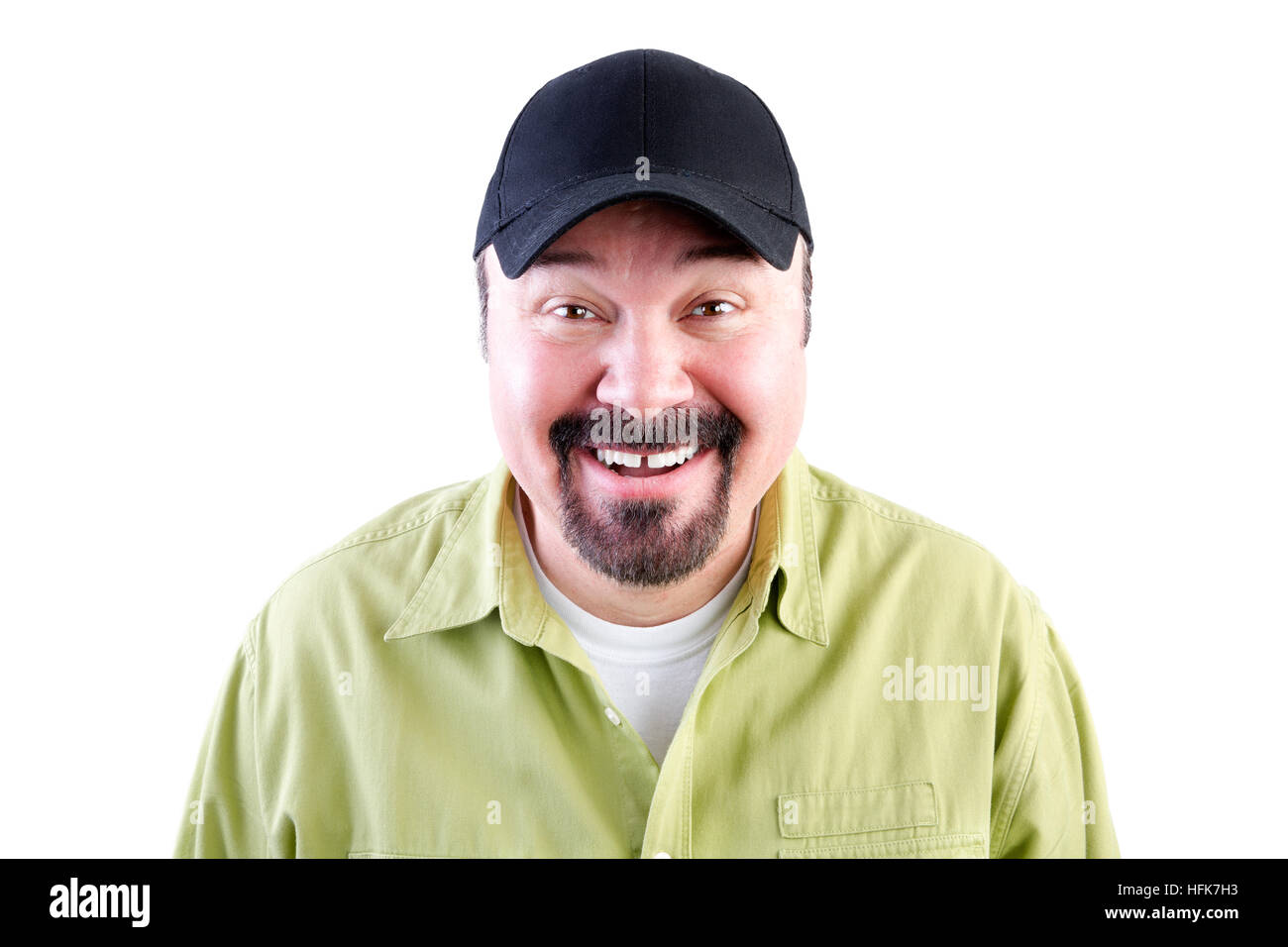 Head and shoulders portrait of grinning man in baseball cap, white background Stock Photo