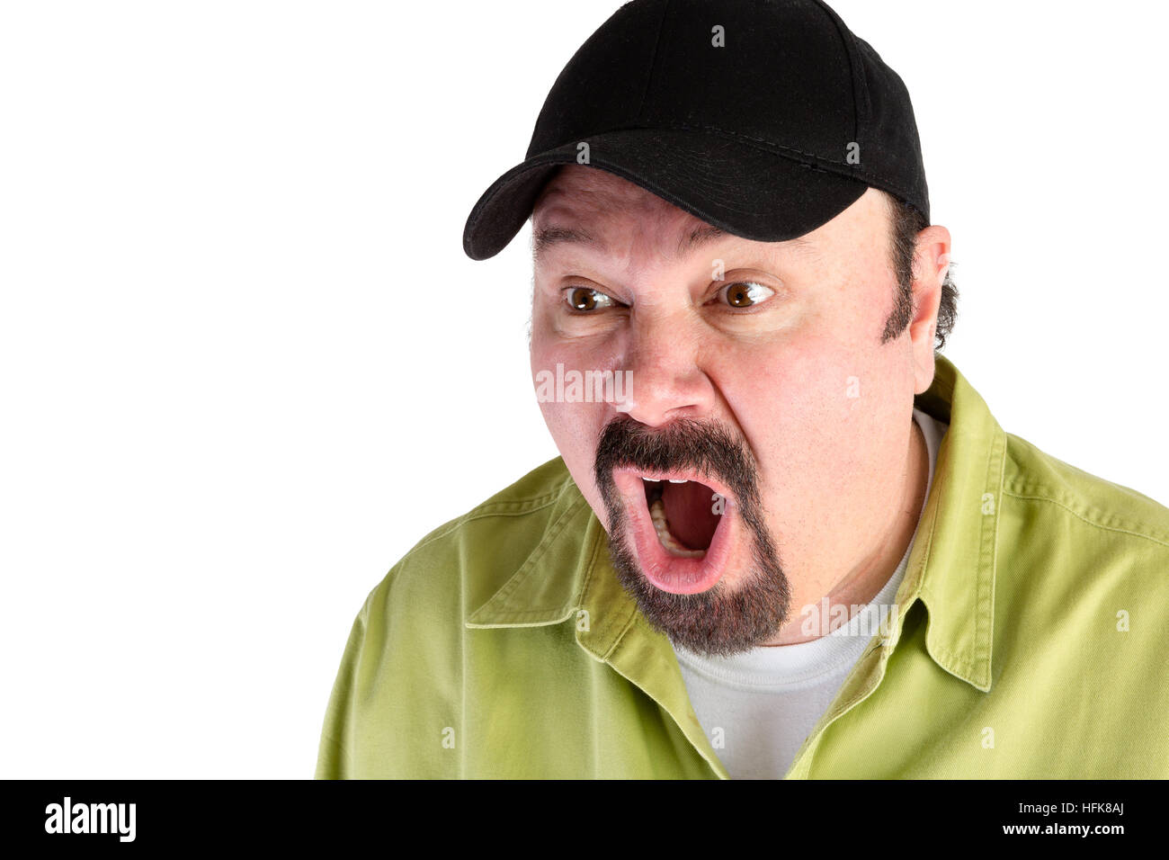 Portrait of horrified man in baseball cap shouting on white with copy space Stock Photo
