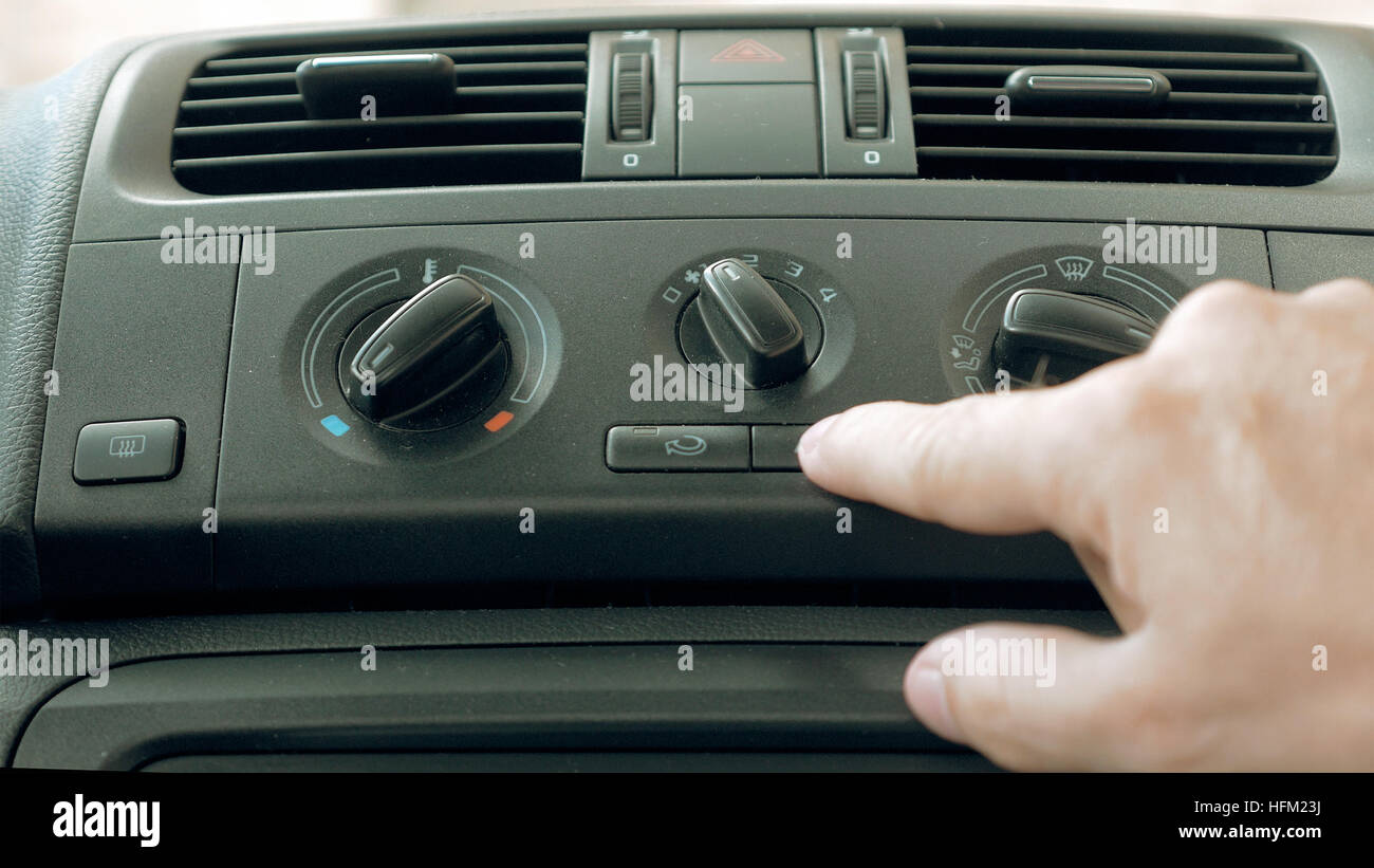 Male hand turning switch of car air conditioner Stock Photo Alamy