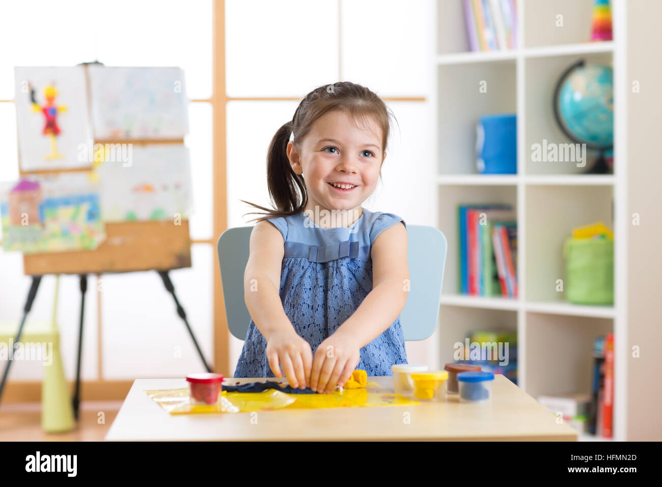 Little kid toddler girl creating toys from playdough Stock Photo Alamy