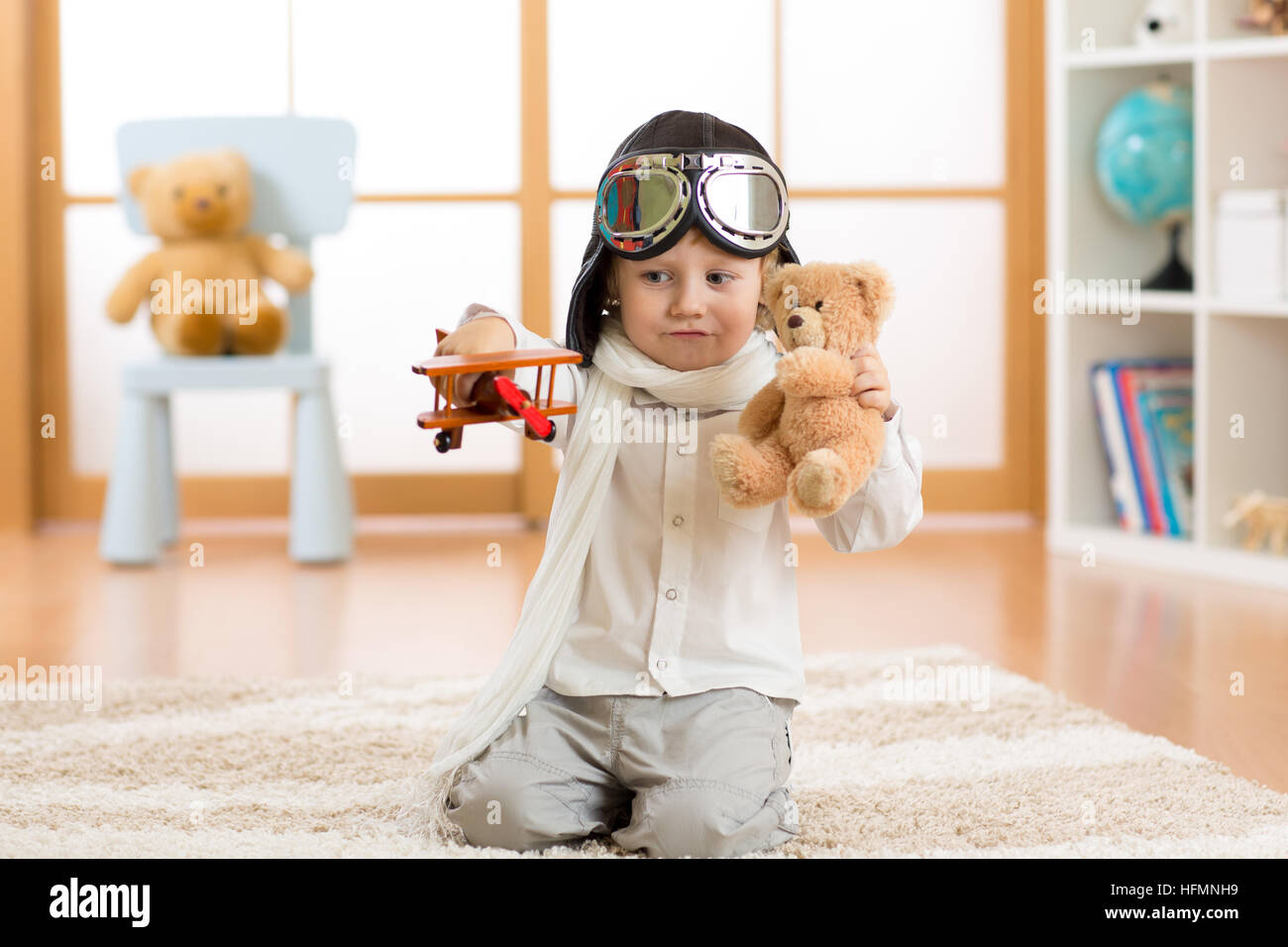 happy child toddler playing with toy airplane and dreaming of becoming a pilot Stock Photo