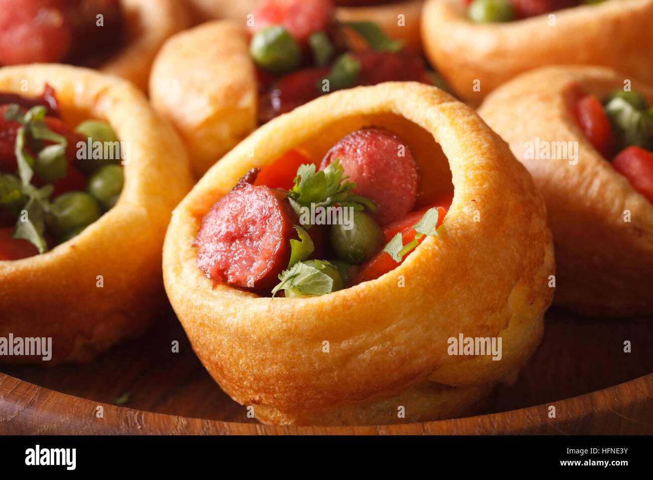 Yorkshire pudding with sausages and vegetables macro. horizontal Stock