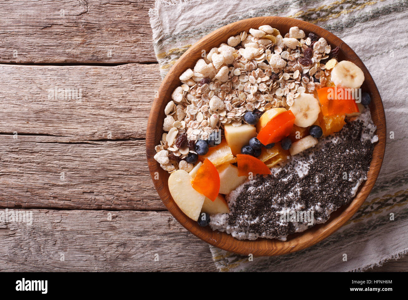 Healthy food: oatmeal with fruit and chia seeds on a plate. horizontal view from above Stock Photo