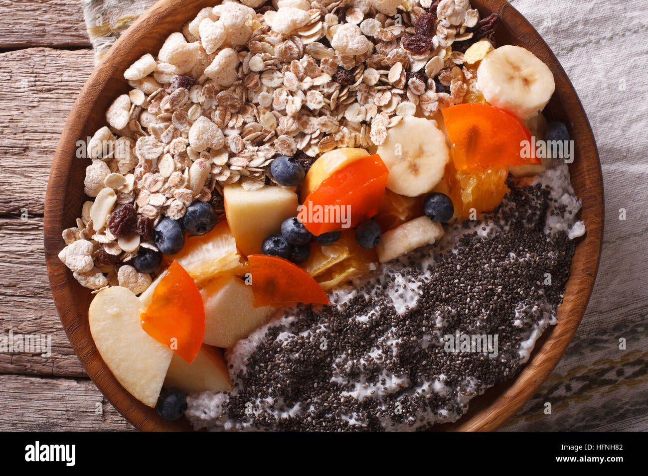 Healthy food: oatmeal with fruit and chia seeds close-up on a plate. horizontal view from above Stock Photo