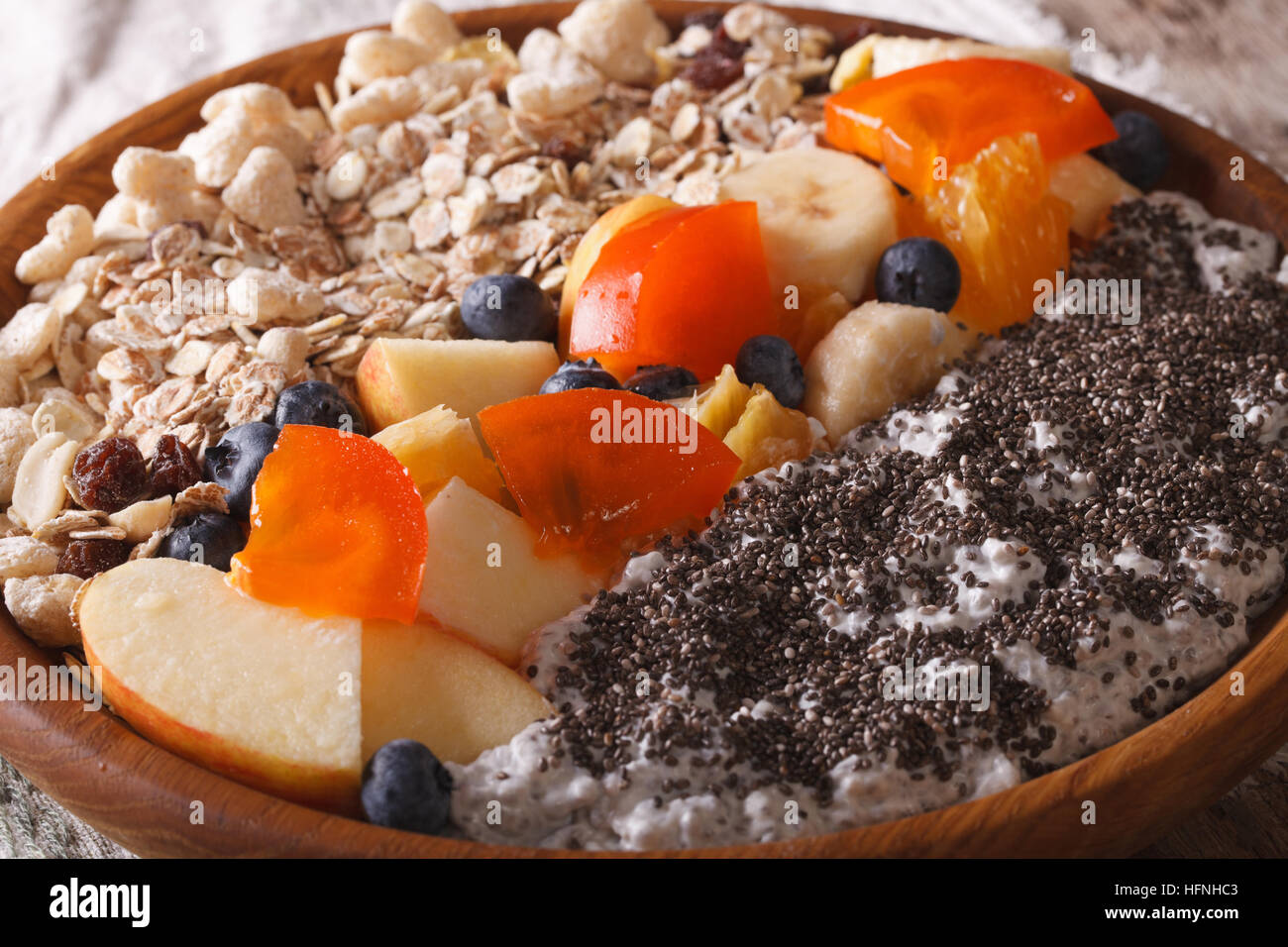 Healthy breakfast: oatmeal with fruit and chia seeds close-up on a plate. horizontal Stock Photo