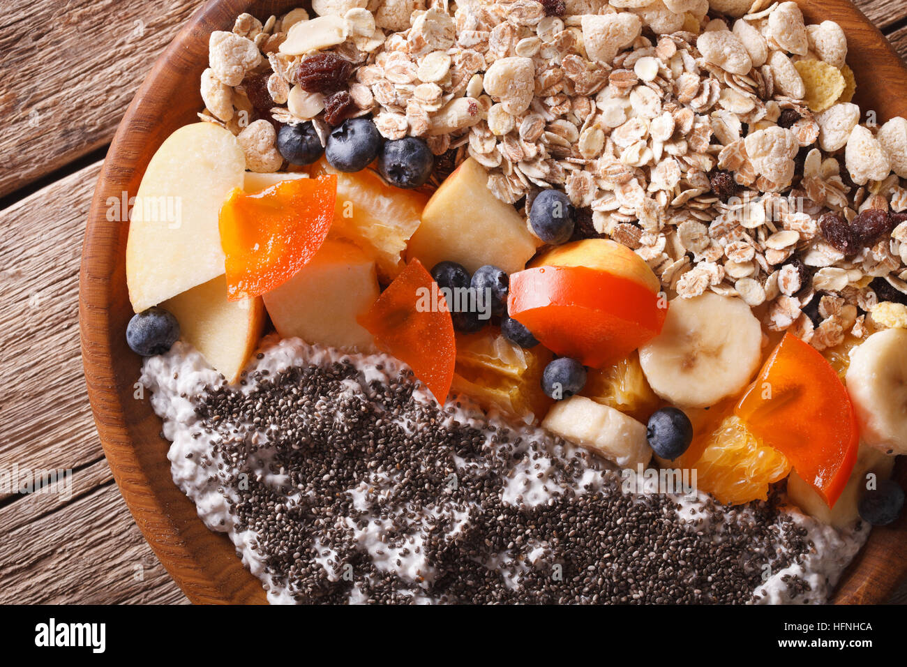 Oatmeal with fruit and chia seeds close-up on a plate. horizontal view from above Stock Photo