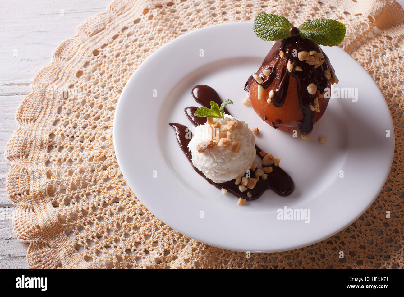 Delicious food: poached pear with chocolate and ice cream on a plate. top view horizontal Stock Photo