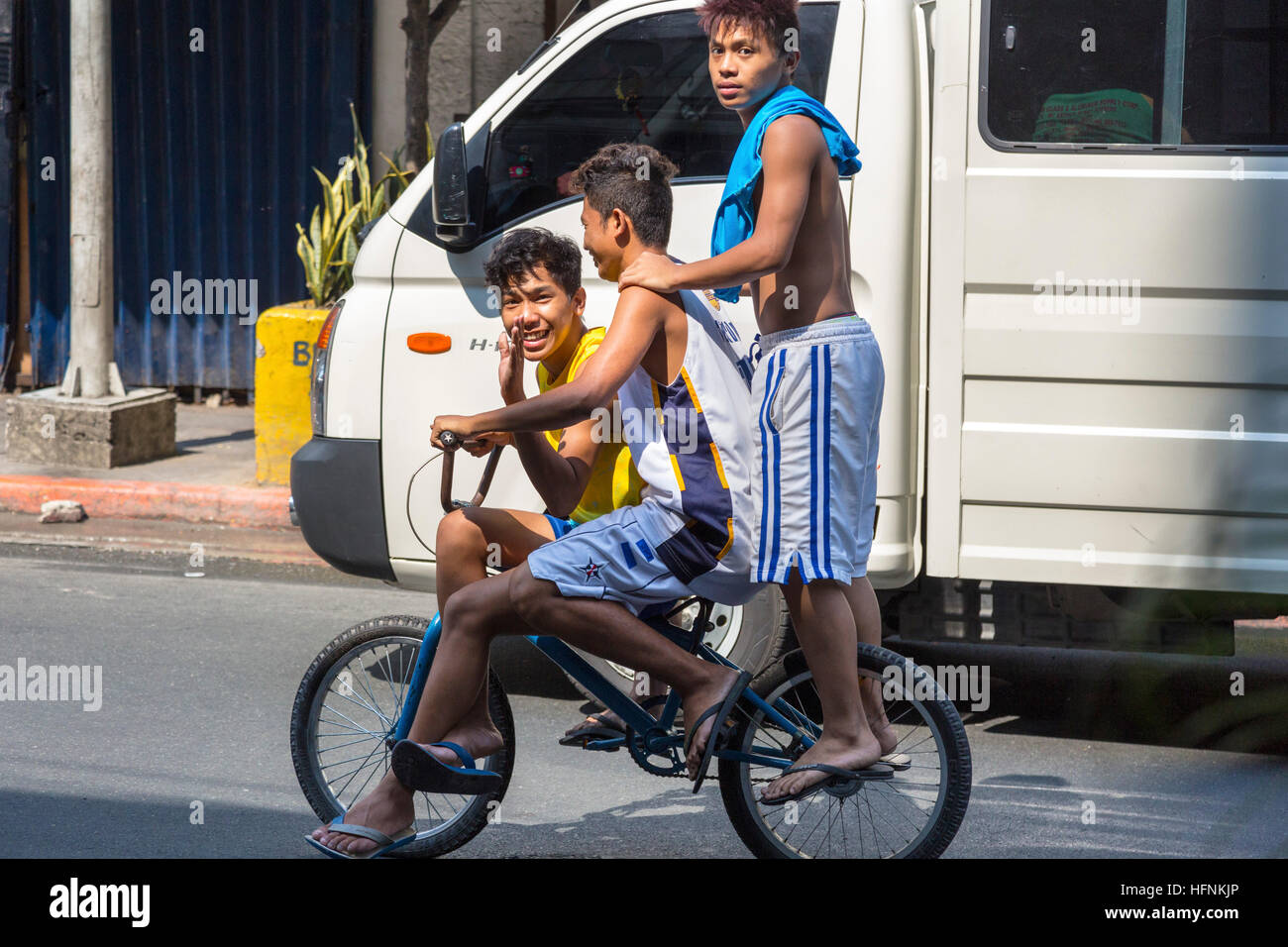 Three kids on a bike, Manila, Philippines Stock Photo Alamy