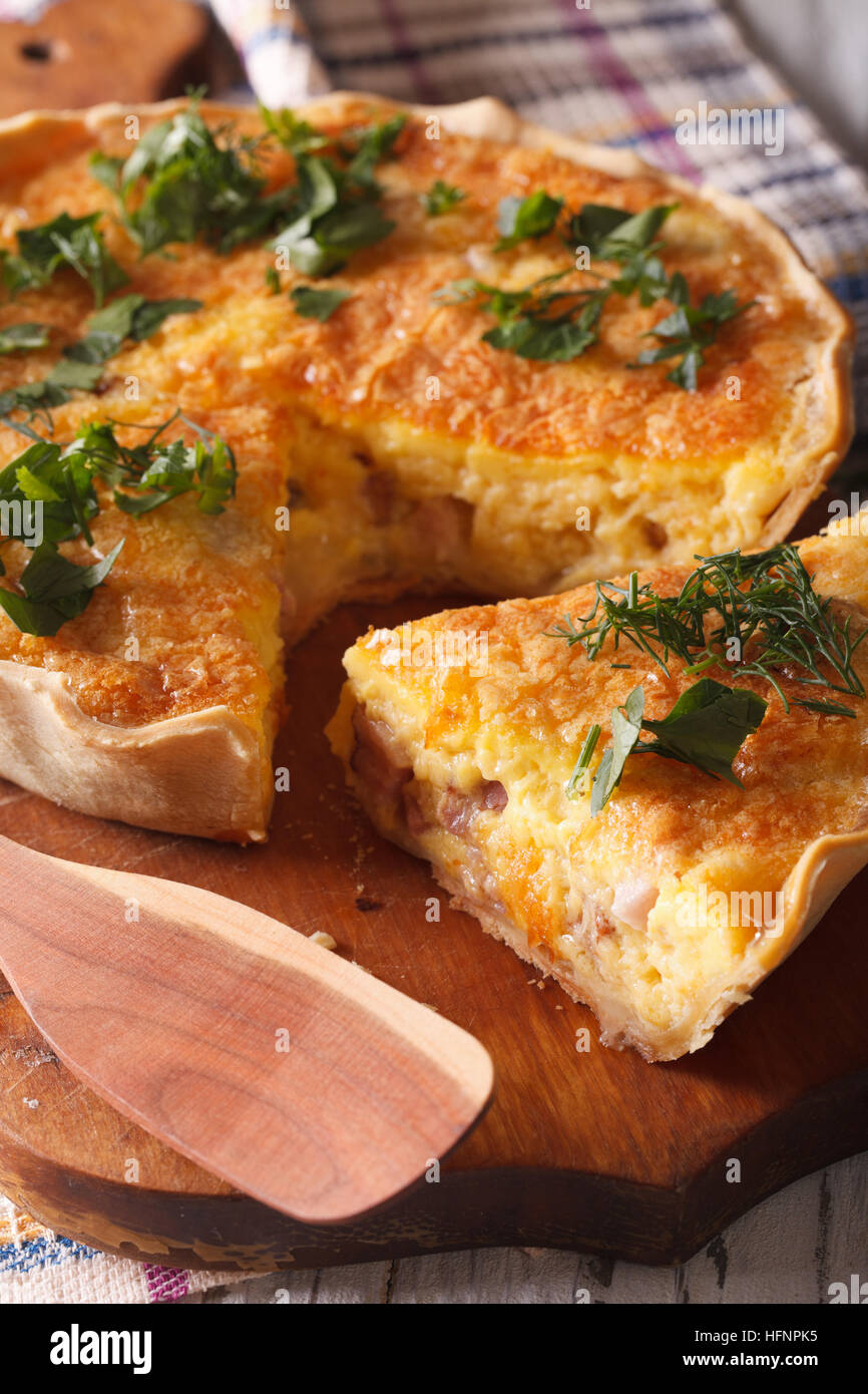 Sliced quiche with cheese, eggs and bacon closeup on a cutting board