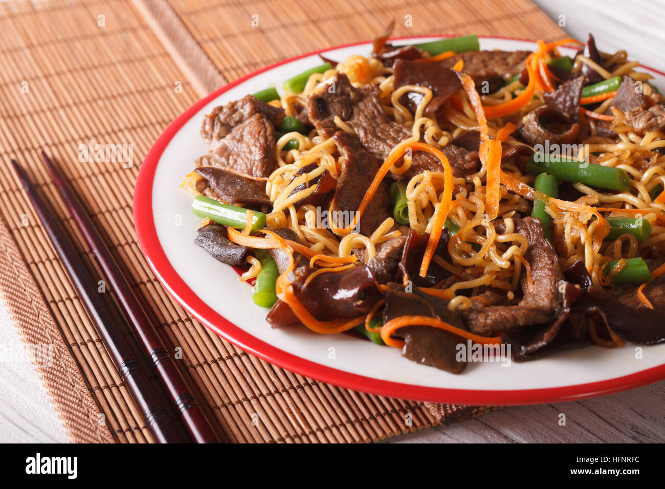 Lo mein with beef, muer and vegetables close-up on a plate. horizontal Stock Photo
