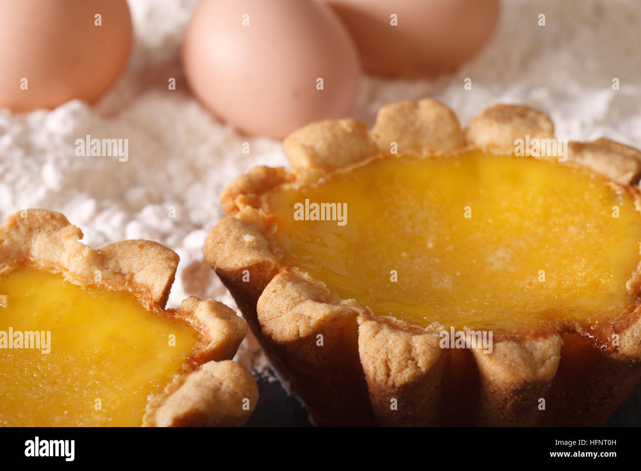 Delicious Egg Tart and ingredients on the table macro. Horizontal Stock Photo