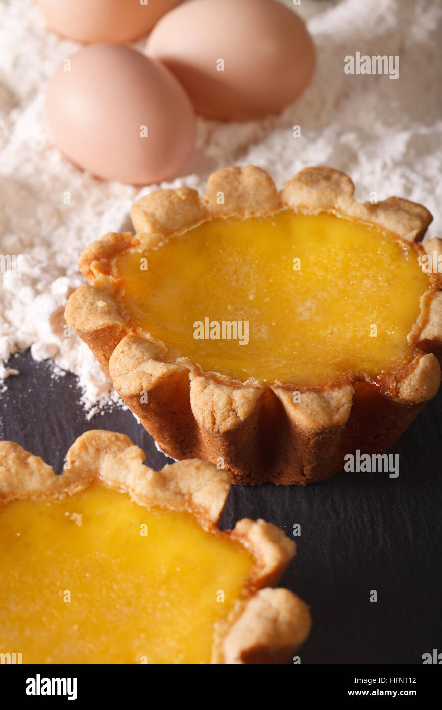 Delicious Egg Tart and ingredients on the table macro. vertical Stock Photo
