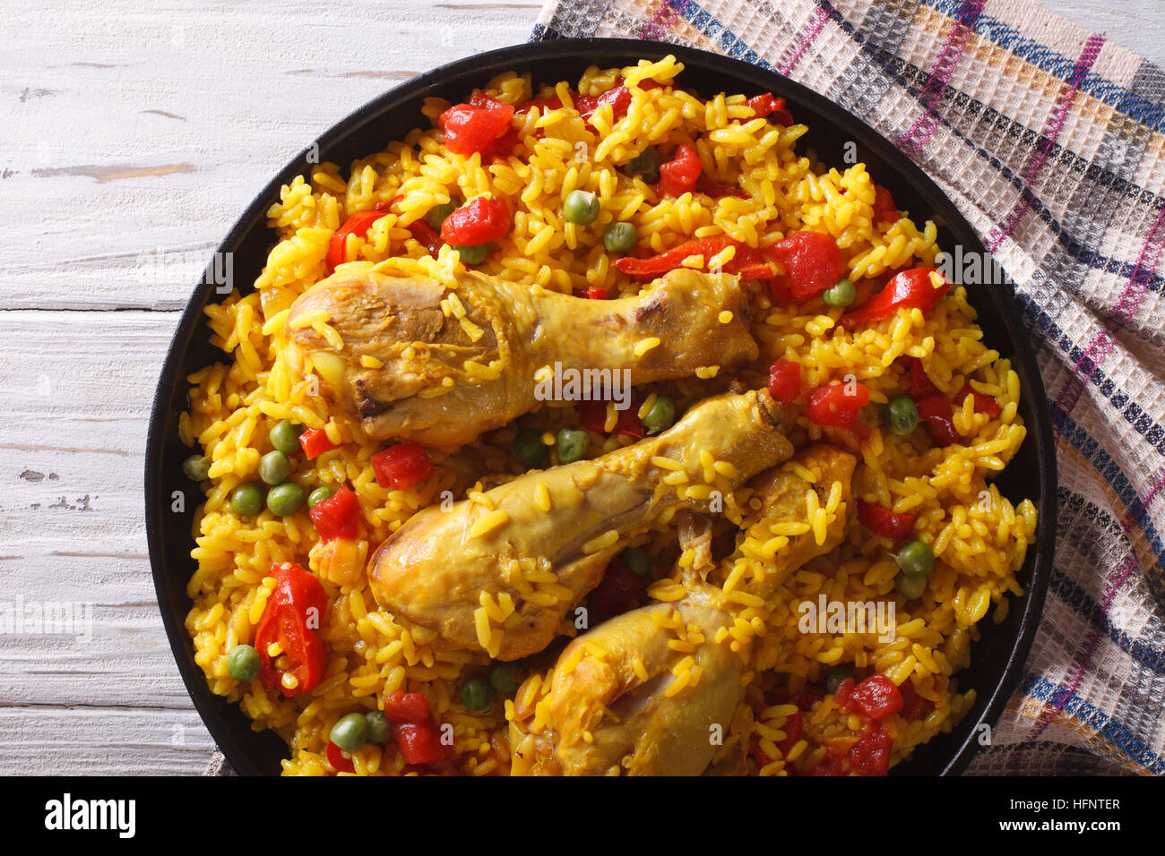 Spanish paella with chicken and vegetables close up on a plate