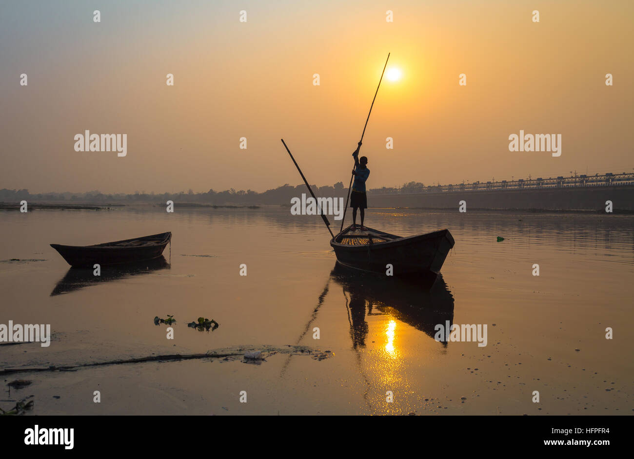Silhouette boat with oarsman at sunset on river Damodar, Durgapur Barrage, West Bengal, India. Stock Photo