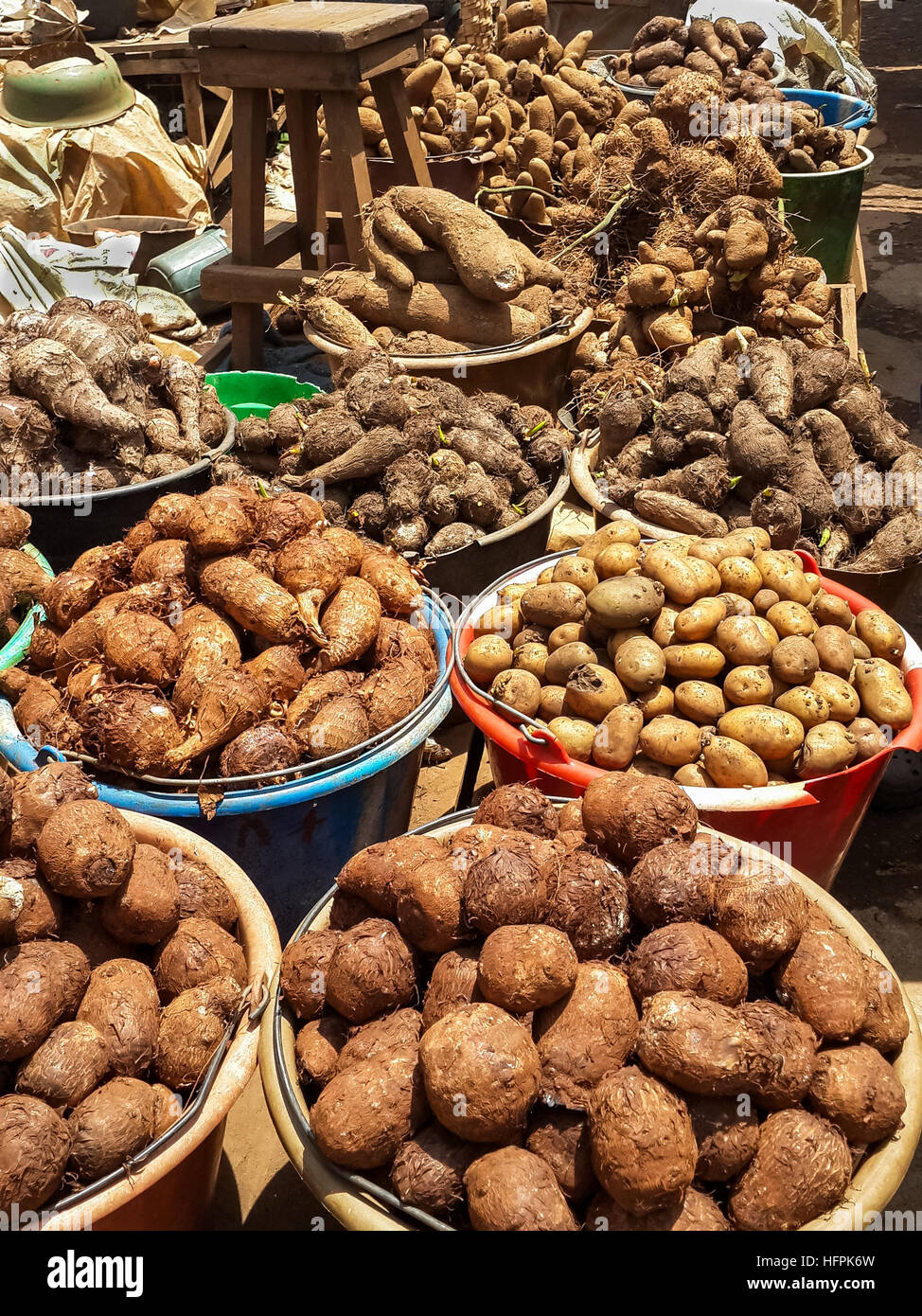 Different root vegetables and potatoes for sale from buckets on local market in Cameroon, Africa Stock Photo