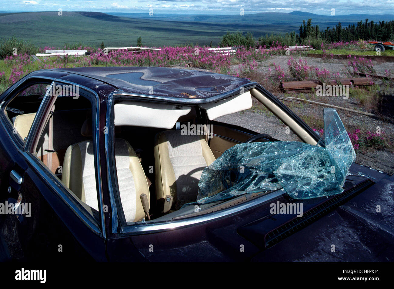 Highway / Road Accident - Badly Smashed Car damaged in Auto Crash - Broken Glass Windshield, Dented Roof Damage Stock Photo