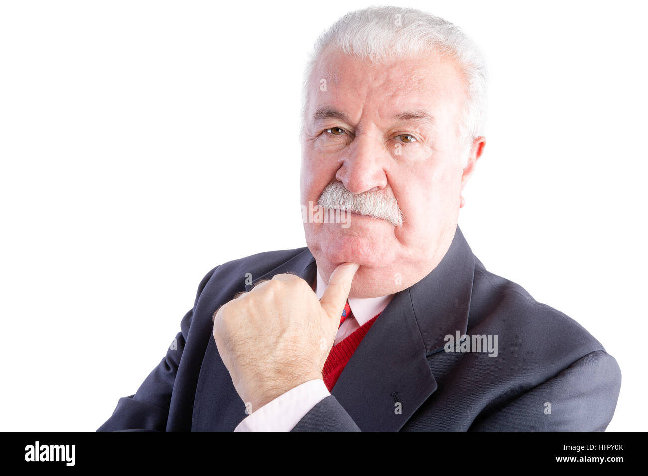 Portrait of elderly businessman in suit resting chin on hand with thoughtful expression, white background Stock Photo