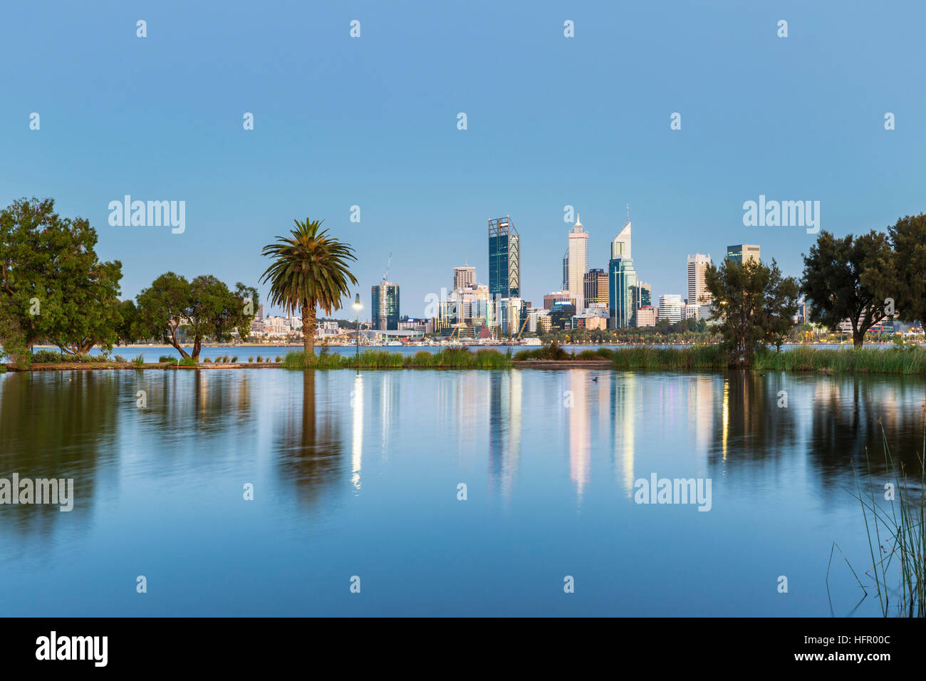 View across St James Mitchell Park and the Swan River to the city skyline at twilight, Perth, Western Australia, Australia Stock Photo