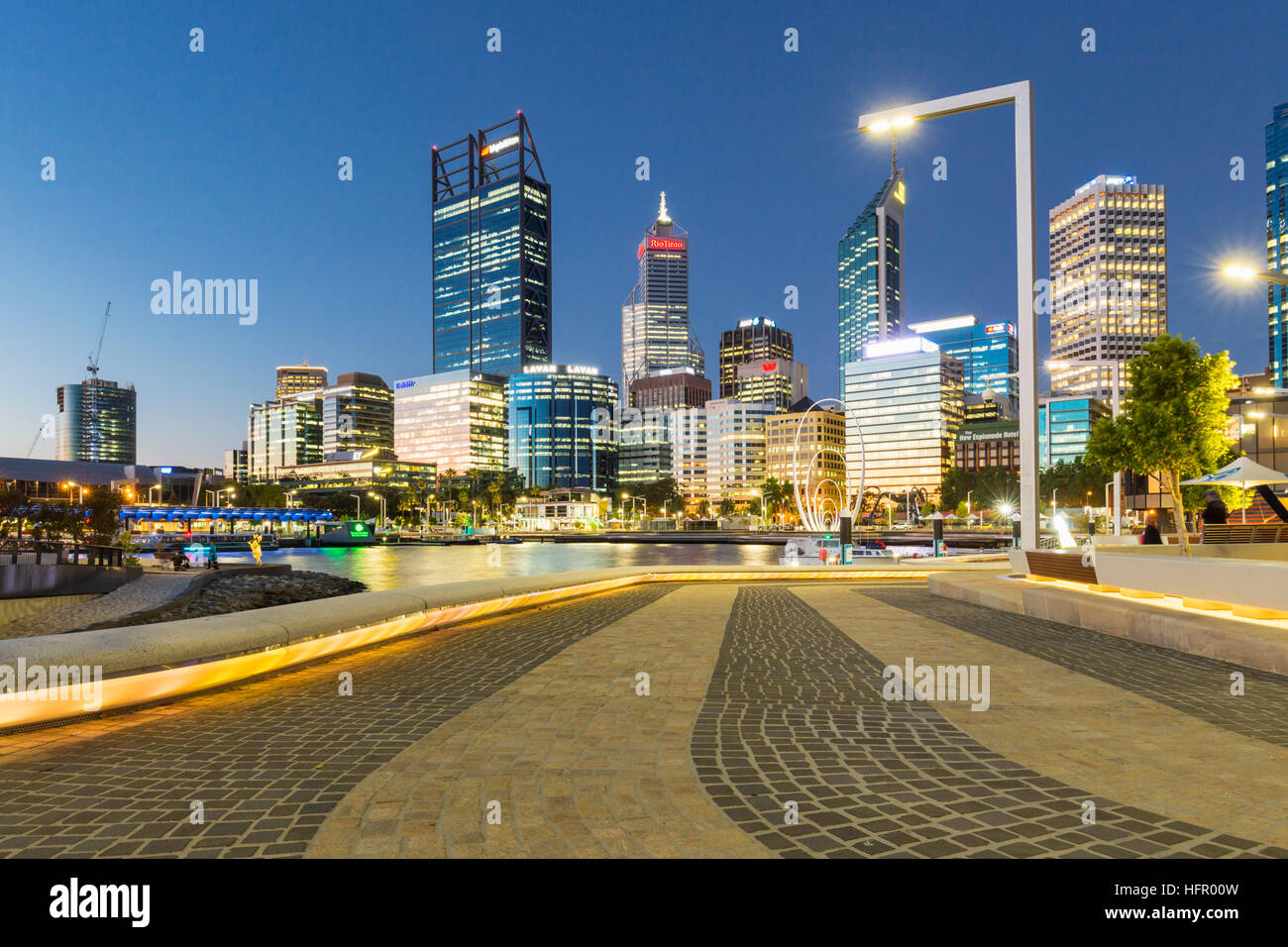 The waterfront precinct of Elizabeth Quay illuminated at twilght with the city skyline beyond, Perth, Western Australia, Australia Stock Photo