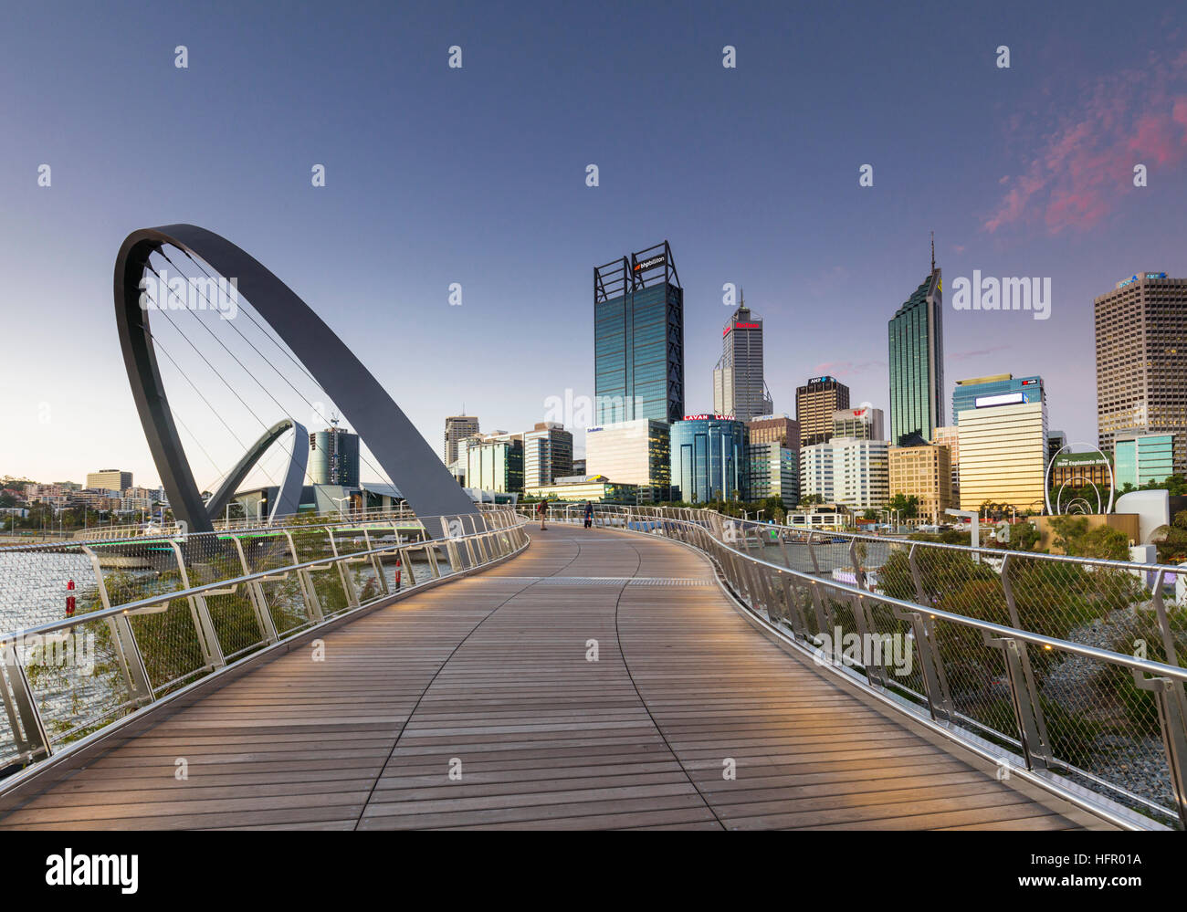 Twilight view along the Elizabeth Quay pedestrian bridge to the city skyline beyond, Perth, Western Australia, Australia Stock Photo