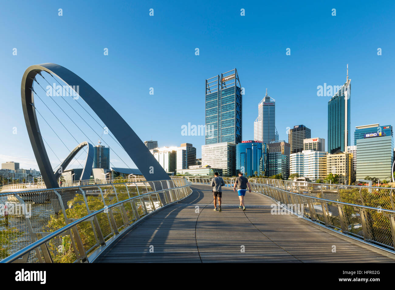 People crossing the Elizabeth Quay pedestrian bridge with the city skyline beyond, Perth, Western Australia, Australia Stock Photo