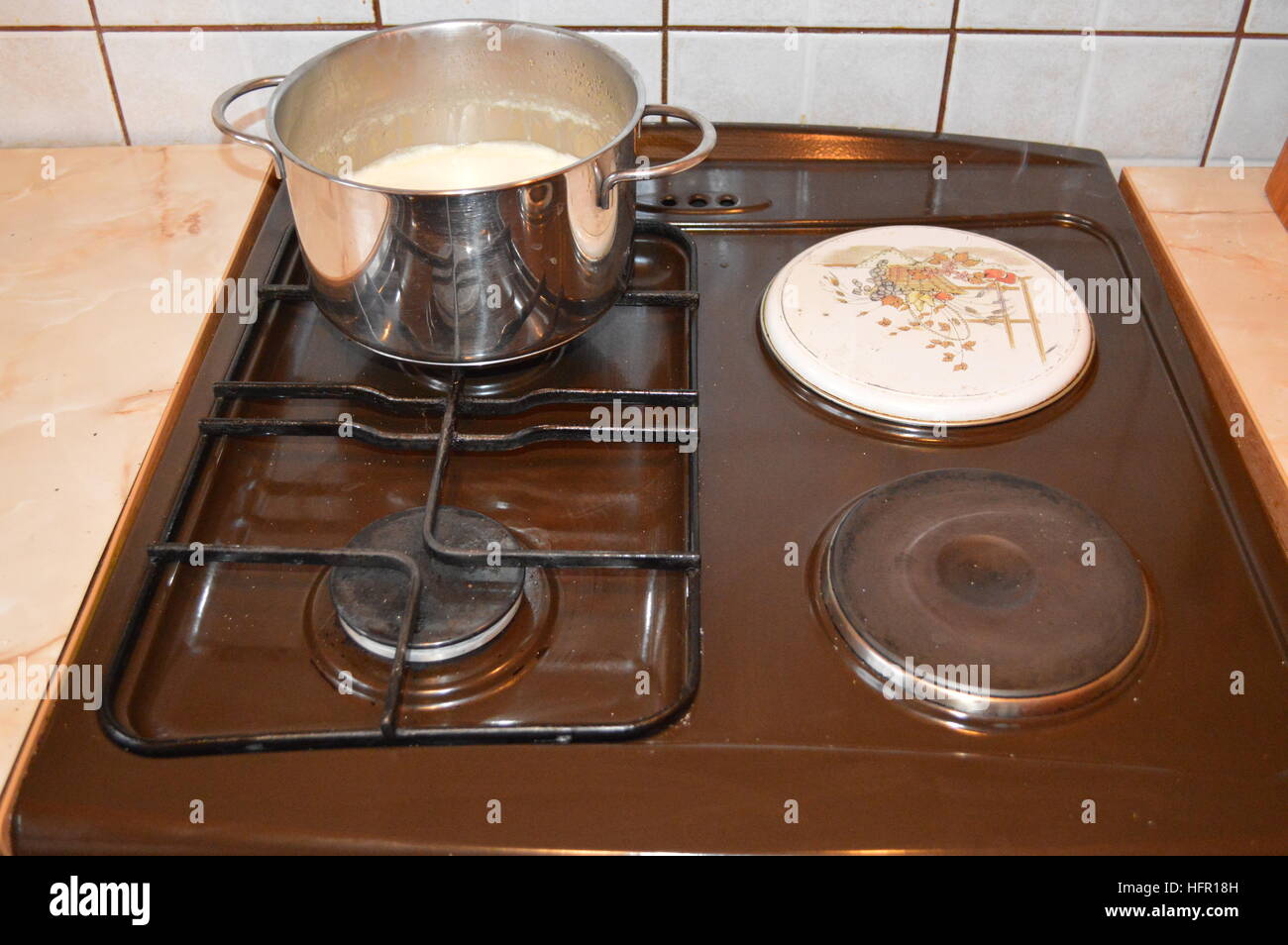Milk in a saucepan on the stove Stock Photo Alamy